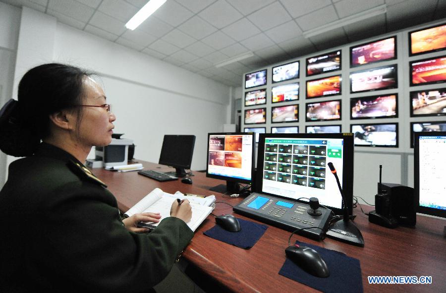 A staff member of Fuquan highway monitors the traffic situation in Fuzhou, capital of capital of southeast China's Fujian Province, Feb. 9, 2013. The highways in China will be toll-free for passenger cars from 0:00 on Feb. 9 to 24:00 on Feb. 15 when most Chinese will go home for the Spring Festival and return to work. (Xinhua/Wei Peiquan)