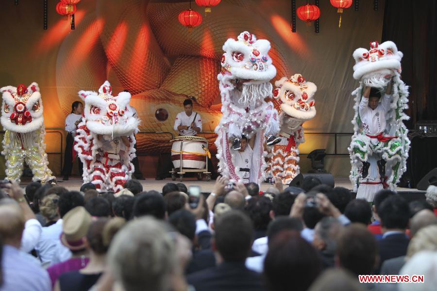 Actors perform traditional lion dance at a ceremony held by Sydney City Council to start a series of events celebrating Chinese Lunar New Year at China Town in Sydney, Australia, Feb. 8, 2013. (Xinhua/Jin Linpeng) 