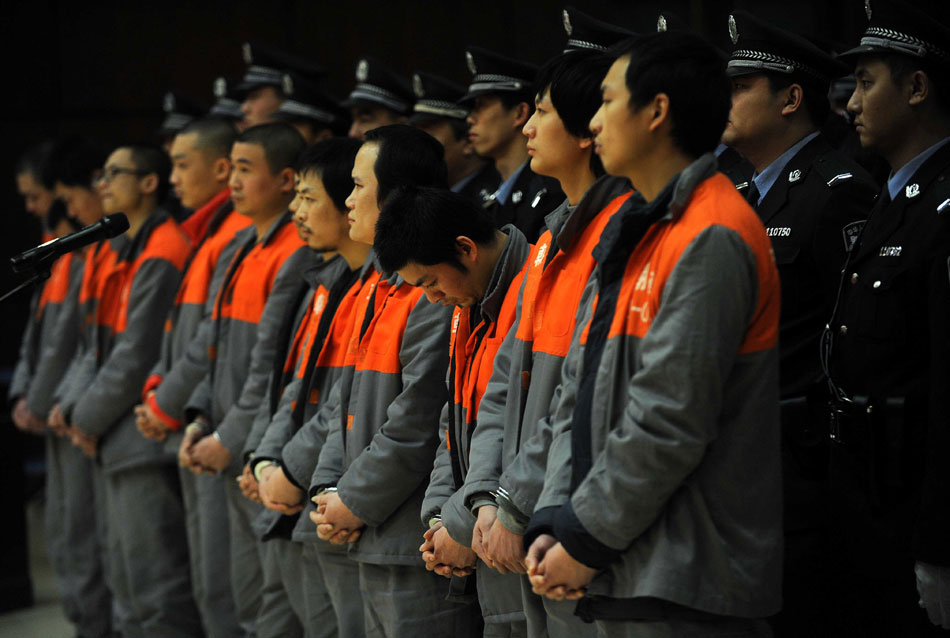 Some of 91 international telecom scammers stand trial in a court in Beijing, Feb. 3. (Xinhua/Gong Lei)