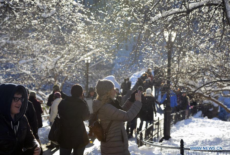 People enjoy themselves inside the Central Park of New York City, on Feb. 9, 2013. A massive blizzard dumped as much as three feet (one meter) of snow in parts of the Northeastern United States, leaving some 650,000 households and businesses without power and two dead by Saturday. (Xinhua/Wang Lei) 