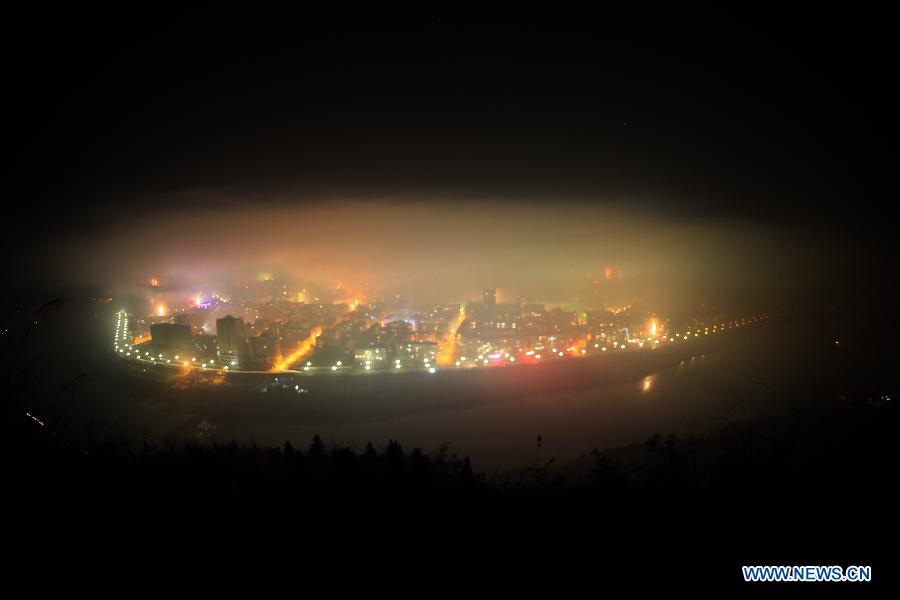Photo taken on 00:13 on Feb. 10, 2013 shows smog covering the downtown area of Zhushan County, central China's Hubei Province, after residents around the area set off fireworks to celebrate the arrival of Chinese Lunar New Year. Setting off fireworks is a tradition in China during the Spring Festival, which result in air pollution in varying degrees. (Xinhua/Zhang Lei) 