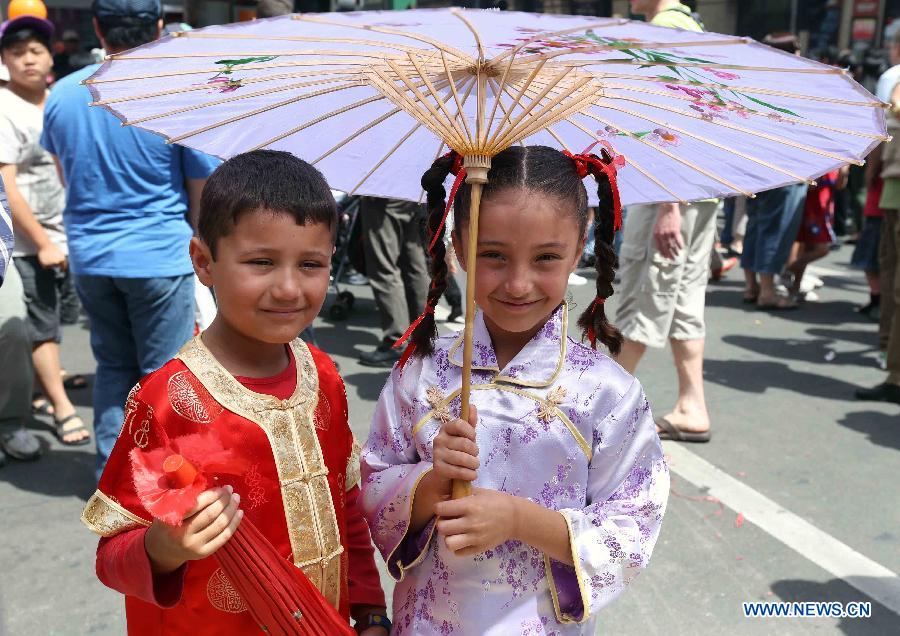 Children wearing traditional Chinese costumes takes part in a parade celebrating the Chinese lunar New Year, in Melbourne, Australia, Feb. 10, 2013. The Chinese Spring Festival falls on Feb. 10 this year, marking the start of the Chinese Year of the Snake. (Xinhua/Xu Yanyan) 