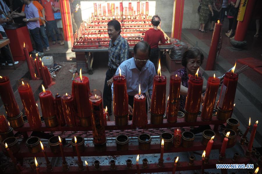 People light up candles to pray at the Satya Budhi Temple in Bandung, Indonesia, Feb. 10, 2013, the Chinese Spring Festival. (Xinhua/Zulkarnain)