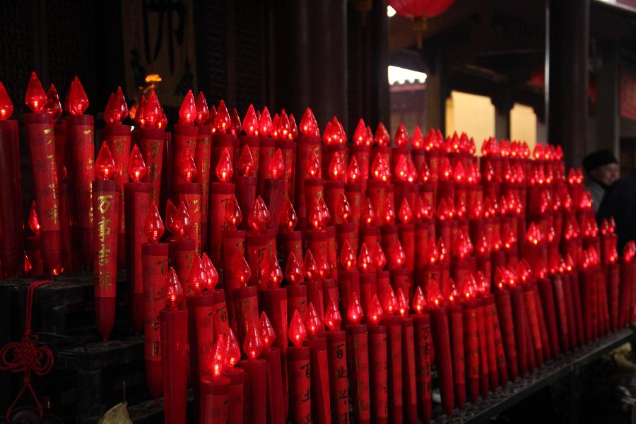 Photo taken on Feb. 11, 2013 shows electric candles with people's wishes in the Faxi Temple in Hangzhou, capital of east China's Zhejiang Province. Many people came to the Faxi Temple to burn incense and pray for blessings for the new year on Monday, the second day of the Chinese lunar New Year. (Xinhua/Ma Ping) 