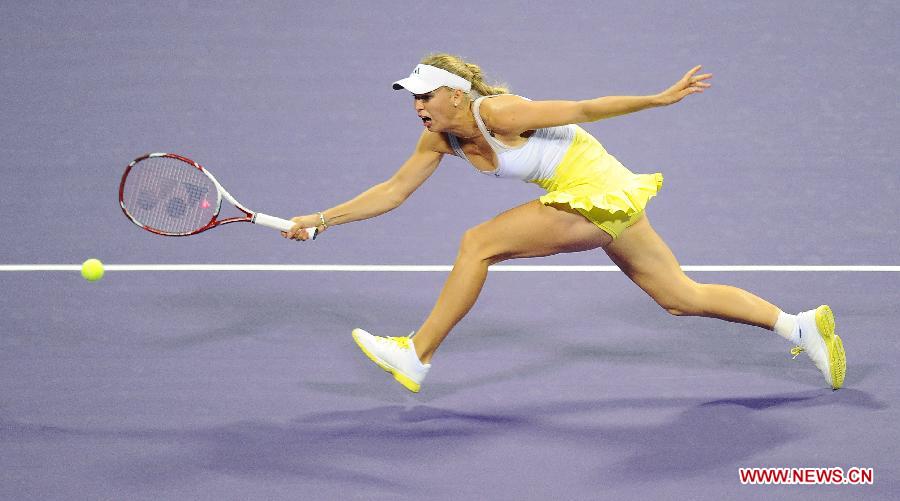 Caroline Wozniacki of Denmark hits a return during the first day of the WTA Qatar Open against Mervana Jugic Salkic of Bosnia in Doha, Qatar, Feb. 11, 2013. Wozniacki won 2-0. (Xinhua/Chen Shaojin) 