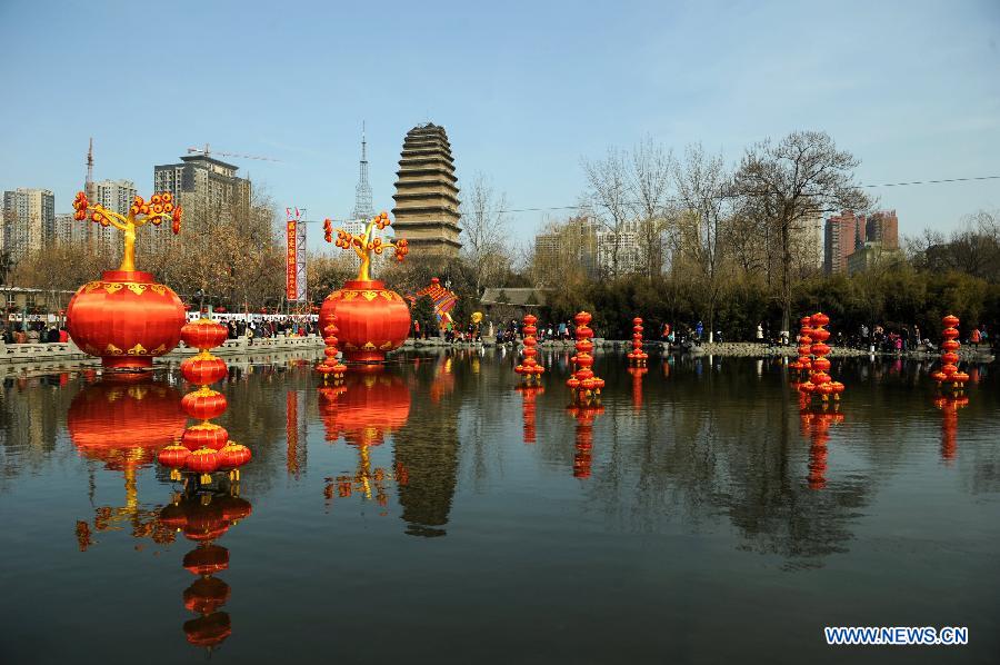 Citizens visit a temple fair near the Xiaoyan Pagoda in Xi'an, capital of northwest China's Shaanxi Province, Feb. 12, 2013. Various activities were held across the country to celebrate the Spring Festival, or the Chinese Lunar New Year. (Xinhua/Li Yibo) 