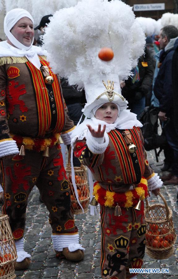 Young Gilles throw oranges during the Binche Carnival in Binche, Belgium, Feb. 12, 2013. Binche Carnival was inscribed on the Representative List of the Intangible Cultural Heritage of Humanity by UNESCO in 2003. (Xinhua/Wang Xiaojun) 