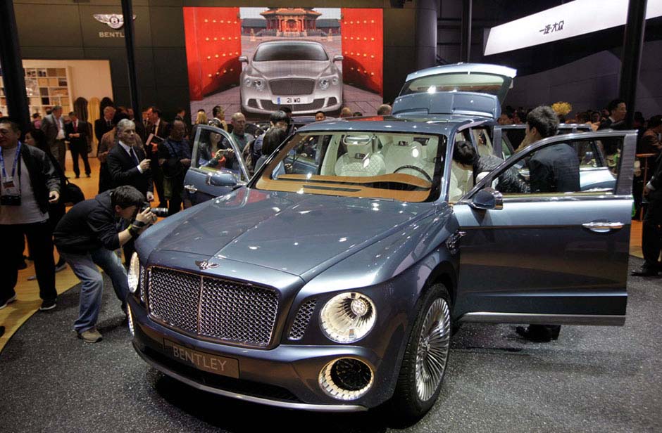 People take pictures of the EXP 9 F Bentley SUV concept car displayed at Auto China 2012 in Beijing on April 23. [Jason Lee / Reuters]