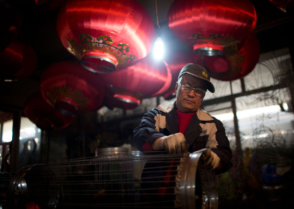 A worker constructs a lantern frame at the workshop in Beijing's Hongmiao village. About 70 lantern frames are made there every day.