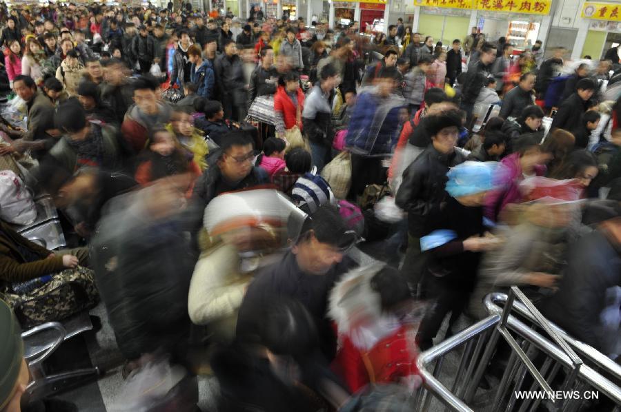 Passengers enter Guiyang Railway Station in Guiyang, capital of southwest China's Guizhou Province, Feb. 15, 2013. China's railways will be tested Friday, when passenger flows peak at the end of the Spring Festival holiday. Some 7.41 million trips will be made on the country's railways with travelers returning to work as the week-long Lunar New Year celebration draws to a close, the Ministry of Railways said. (Xinhua/Ou Dongqu)