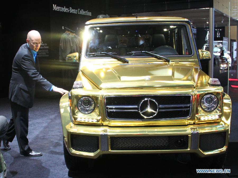 A visitor touches a Mercedes-Benz G63 AMG on display during the 40th Canadian International Auto Show at the Metro Toronto Convention Center in Toronto, Canada, Feb. 14, 2013. The 11-day Canadian International Auto Show kicked off on Thursday in Toronto with about one thousand vehicles from over 120 exhibitors being displayed. (Xinhua/Zhang Ziqian)