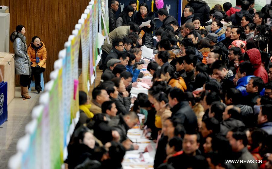 People attend a job fair in Jinhu County, east China's Jiangsu Province, Feb. 15, 2013. As the Spring Festival holiday draws to a close, various job hunting fairs are held among cities across the country. (Xinhua/Chen Yibao)