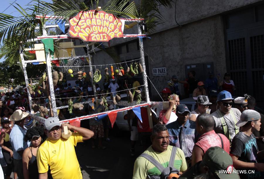 People attend the popular party called "El Entierro de la Sardina", in Naiguata, in the state of Vargas, Venezuala, on Feb. 14, 2013. The popular party "El Entierro de la Sardina" marks the end of the Carnival celebrations. (Xinhua/Juan Carlos La Cruz/AVN)