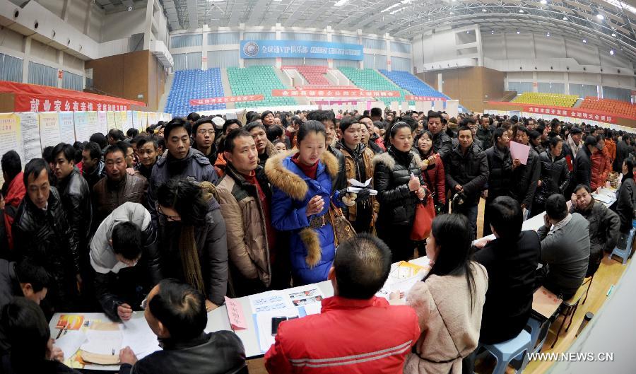 People attend a job fair in Jinhu County, east China's Jiangsu Province, Feb. 15, 2013. As the Spring Festival holiday draws to a close, various job hunting fairs are held among cities across the country. (Xinhua/Chen Yibao) 