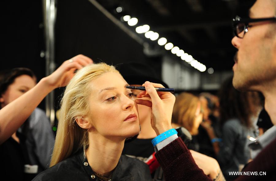 A model gets her makeup done at the backstage before the presentation of Ralph Lauren 2013 Fall collections of the Mercedes-Benz Fashion Week in New York, Feb. 14, 2013. (Xinhua/Deng Jian) 