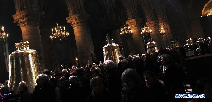 People visit the nine new bronze bells inside Notre Dame de Paris cathedral in Paris, France, Feb. 15, 2013. Notre Dame in Paris will celebrate its 850th anniversary on March 23. Nine new bells will be installed on the cathedral's twin towers to recreate the harmonious chimes before the French Revolution. The new bells are now on display for the public at Notre Dame before ringing on the cathedrale's 850th birthday. (Xinhua/Gao Jing)