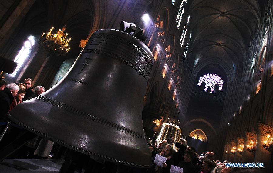 People visit the nine new bronze bells inside Notre Dame de Paris cathedral in Paris, France, Feb. 15, 2013. Notre Dame in Paris will celebrate its 850th anniversary on March 23. Nine new bells will be installed on the cathedral's twin towers to recreate the harmonious chimes before the French Revolution. The new bells are now on display for the public at Notre Dame before ringing on the cathedrale's 850th birthday. (Xinhua/Gao Jing)