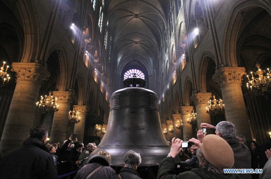 People visit the nine new bronze bells inside Notre Dame de Paris cathedral in Paris, France, Feb. 15, 2013. Notre Dame in Paris will celebrate its 850th anniversary on March 23. Nine new bells will be installed on the cathedral's twin towers to recreate the harmonious chimes before the French Revolution. The new bells are now on display for the public at Notre Dame before ringing on the cathedrale's 850th birthday. (Xinhua/Gao Jing)