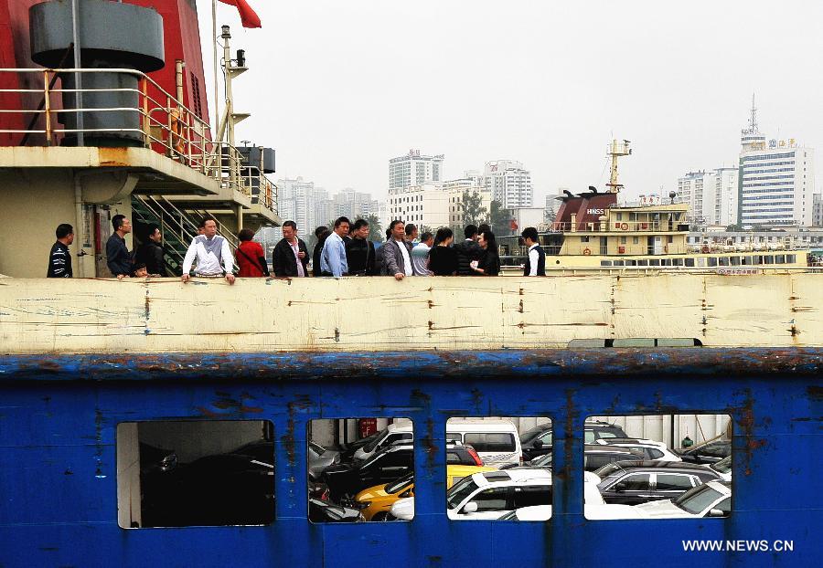 Passengers and vehicles detained by a heavy fog are seen on board a ro-ro ship at a port in Haikou, capital of south China's Hainan Province, Feb. 16, 2013. A total of 46,000 passengers and 8,700 vehicles have left the Port of Haikou from 8:00 p.m. Friday to 8:00 a.m. Saturday, after being detained by a heavy fog that disrupted the waterway traffic across the Qiongzhou Strait. (Xinhua/Wei Hua)  