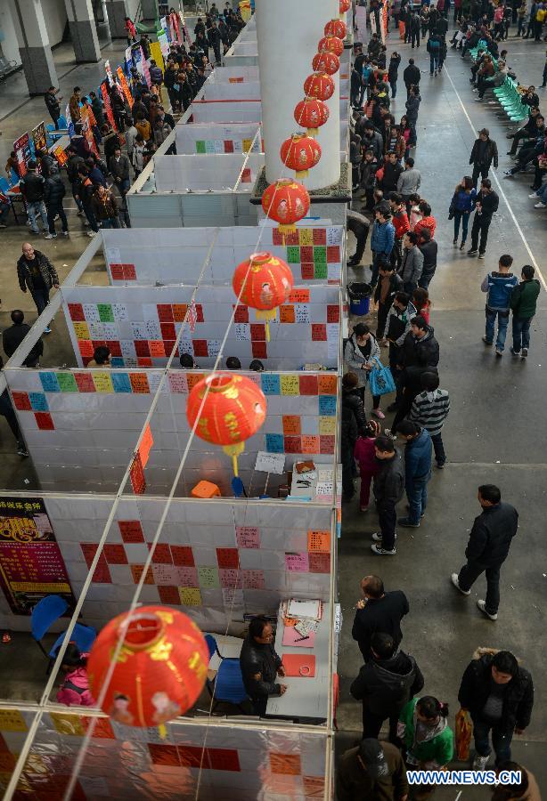 People look for career opportunities at a job fair in Yiwu, east China's Zhejiang Province, Feb. 16, 2013. China has begun to see a resurgence in the number of both employers and job seekers after the week-long Spring Festival holiday. (Xinhua/Han Chuanhao) 