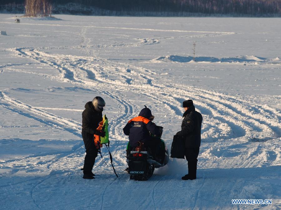 A member of Russian ministry of emergency situations (C) rides a snow motorbike to the site of the meteorite fall at the chebarkul lake near Chelyabinsk, about 1500 kilometers east of Moscow, Russia, Feb. 16, 2013. A meteorite burst into the sky over Russia's Urals region on Friday. Emergency Situations Minister Vladimir Puchkov said there was no proof that meteoritic fragments have been found. (Xinhua/Jiang Kehong)