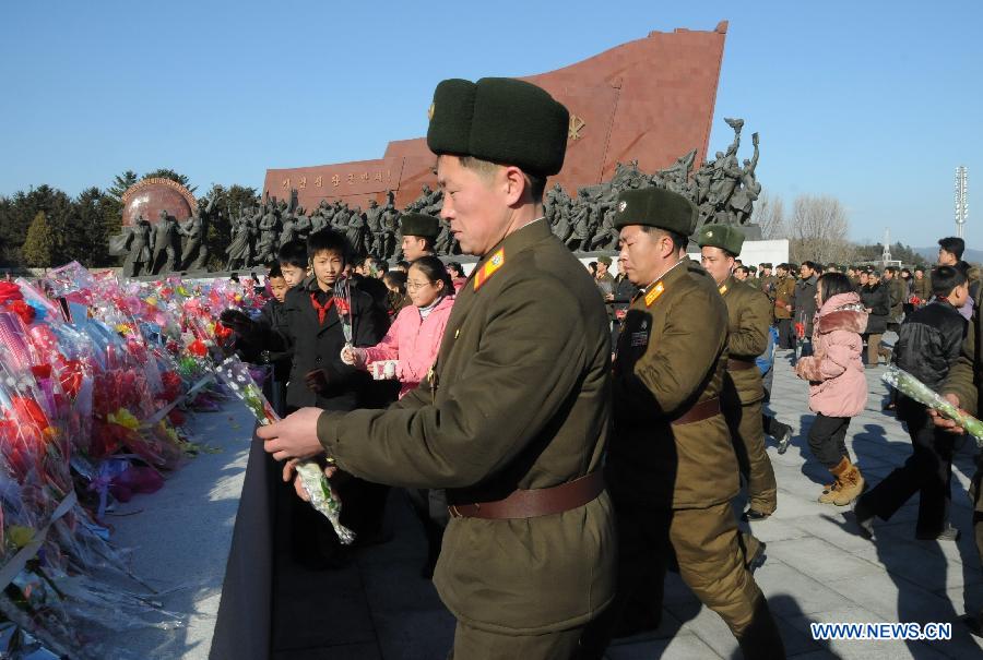 People present flowers in front of the statues of Kim Il Sung and Kim Jong Il to mark the 71st anniversary of the birth of late leader Kim Jong Il in Pyongyang, capital of the Democratic People's Republic of Korea (DPRK), Feb. 15, 2013. The 71st birthday of late leader Kim Jong Il falls on Feb. 16. (Xinhua/Du Baiyu)