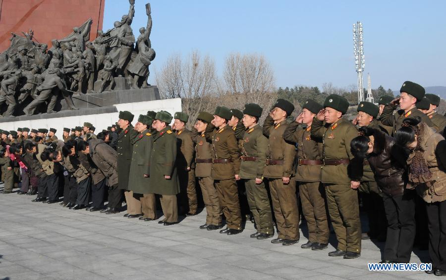 People salute in front of the statues of Kim Il Sung and Kim Jong Il to mark the 71st anniversary of the birth of late leader Kim Jong Il in Pyongyang, capital of the Democratic People's Republic of Korea (DPRK), Feb. 15, 2013. The 71st birthday of late leader Kim Jong Il falls on Feb. 16. (Xinhua/Du Baiyu)
