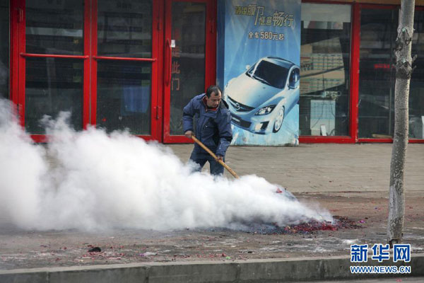 A man is cleaning firework debris on a street in Shenyang, northeastern China's Liaoning province, Saturday morning, February 16, 2013. Firework sprees are staged in many places around China on Saturday morning, the first workday after this year's Spring Festival holidays. Many Chinese businessmen pray this way for a properous new year, but such activities have also been blamed for burdening cleaning workers and worsening air pullution. (Photo/Xinhua) 