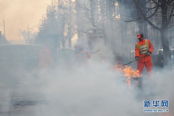 Street cleaning workers are trying to sweep away firework debris on a street in Dalian, northeast China's Liaoning province, Saturday morning, February 16, 2013. Firework sprees are staged in many places around China on Saturday morning, the first workday after this year's Spring Festival holidays. Many Chinese businessmen pray this way for a properous new year, but such activities have also been blamed for burdening cleaning workers and worsening air pullution. (Photo/Xinhua）