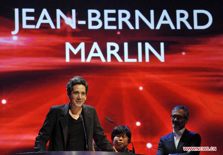 Director Jean-Bernand Marlin addresses the audience after receiving the Golden Bear award for best film of the International Short film jury for "La Fugue" (The Runaway) during the awards ceremony at the 63rd Berlinale International Film Festival in Berlin, Feb. 16, 2013. (Xinhua/Ma Ning) 