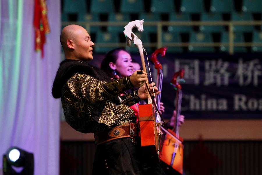 China Shenjun Band plays the horse head string instruments during the performances of the Embrace China Art Group of the All-China Federation of Returned Overseas Chinese in Nairobi, Kenya, Feb. 16, 2013. (Xinhua/Meng Chenguang) 