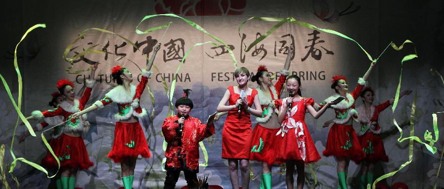 Dancers perform during a show by China's "Cultures of China, Festival of Spring" art group in Paris, capital of France, Feb. 16, 2013. (Xinhua/Gao Jing) 