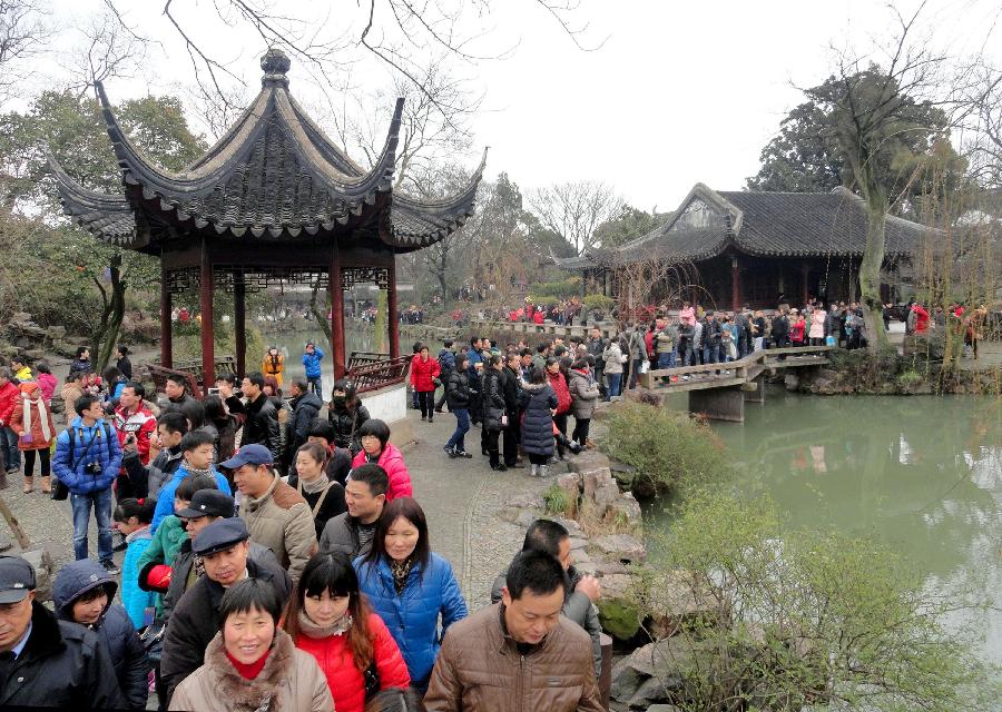 Tourists visit the Humble Administrator's Garden in Suzhou, east China's Jiangsu Province, Feb. 13, 2013. The number of tourists during the week-long Spring Festival holiday topped 203 million across the country, up 15.1 percent from the same period last year, according to the latest statistics by the National Tourism Administration. The Spring Festival, or the Chinese Lunar New Year, fell on Feb. 10 this year. (Xinhua/Wang Jiankang) 