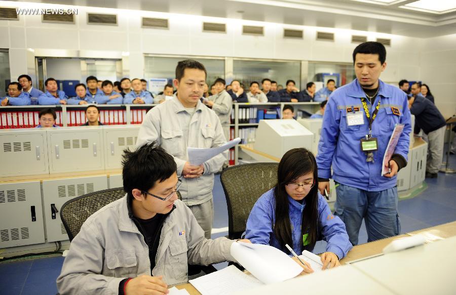 Staff work in the main control room of first unit of Hongyanhe nuclear power station near Wafangdian, northeast China's Liaoning Province, Feb. 17, 2013. The Hongyanhe nuclear power station, the first nuclear power plant and largest energy project in northeast China, started operation on Sunday afternoon. Construction on the first phase of the project, which features four power generation units to be built at a cost of 50 billion yuan (7.96 billion U.S. dollars), began in 2007 and is expected to be completed by the end of 2015. The four units will generate 30 billion kilowatt-hours (kwh) of electricity annually by then. Construction on the second phase of the project, which features two power generation units to be built with an investment of 25 billion yuan, started in May 2010 and is expected to be completed by the end of 2016. The power plant will generate 45 billion kwh of electricity after it is fully completed in 2016. (Xinhua)