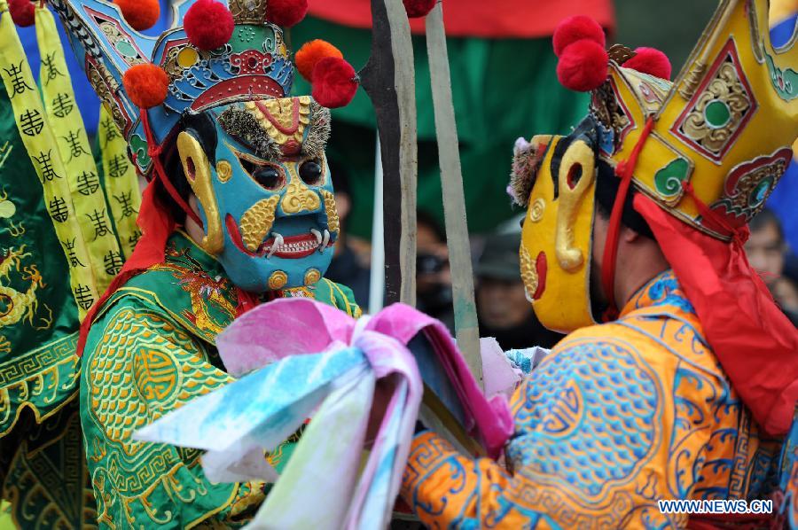 Performers perform Nuo dance, a kind of exorcising dance, during the 14th Folk Culture Festival in Liyang City, east China's Jiangsu Province, Feb. 17, 2013. (Xinhua/Han Yuqing)