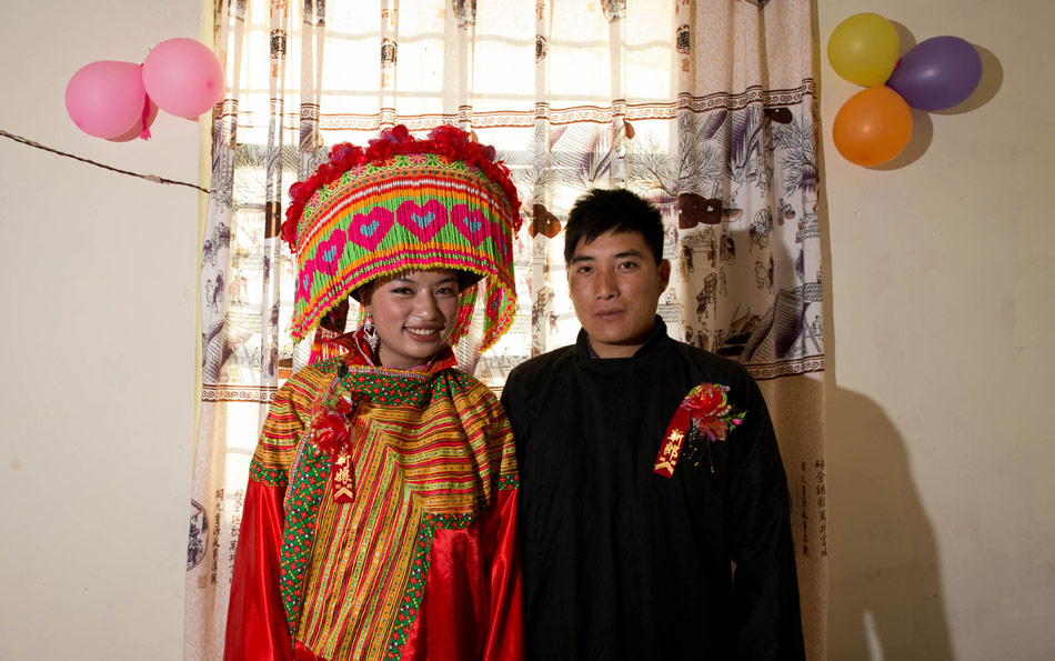 Zhang Lu (the bride) and Ji Junxiang (the bridegroom) pose for photos in their wedding room on Feb. 15, 2013. (Xinhua/Jiang Hongjing)
