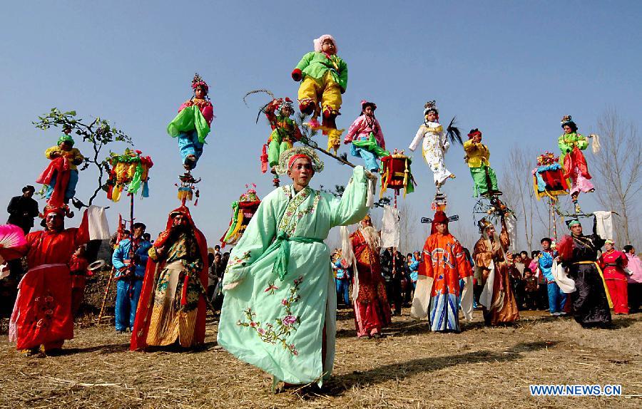 File photo taken on Feb. 11, 2006 shows Shehuo performers staging a show in Xidian Village of Songxian County, central China's Henan Province. (Xinhua/Wang Song)