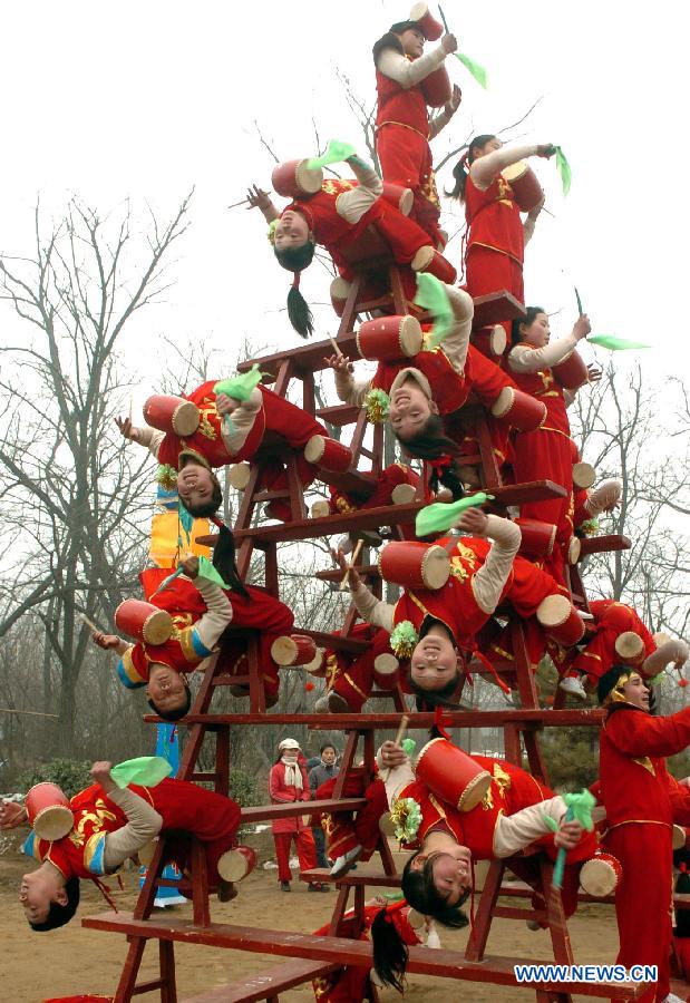 File photo taken on Jan. 29, 2006 shows young Shehuo performers staging a drum show at a temple fair in Zhengzhou, capital of central China's Henan Province. (Xinhua/Wang Song)