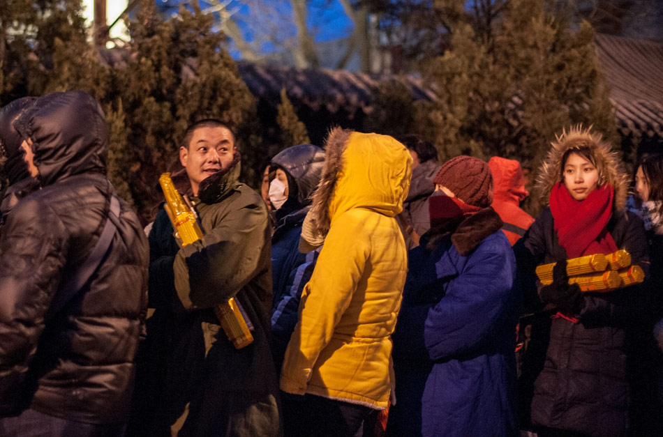 The pilgrims queue outside the Lama Temple through the night on Feb. 10, 2013, the Lunar New Year's Day. Many Beijing residents came to the Lama Temple to pray for peace and prosperity for the year to come. The number of pilgrims reached 1.8 million before 10 a.m. in the morning. (Xinhua/Zhang Yu)