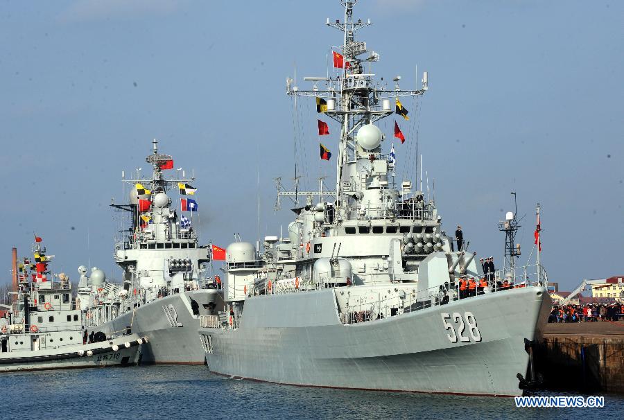 A missile frigate "Mianyang" (R) and a missile destroyer "Harbin" wait at a port in Qingdao City, east China's Shandong Province, Feb. 16, 2013, preparing to depart for the Gulf of Aden and the sea off Somalia on escort missions. The flotilla, as the 14th batch of its kind to engage in escort missions, consists of a missile destroyer and a frigate as well as a supply ship which are all from the North Sea Fleet of the People's Liberation Army (PLA) Navy. (Xinhua/Li Ziheng) 