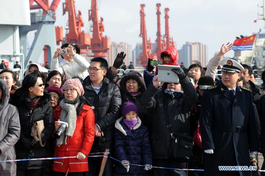 Family members and friends of a Chinese flotilla's crew members bid farewell to the flotilla, which will depart for the Gulf of Aden and the sea off Somalia to conduct escort missions, at a port in Qingdao City, east China's Shandong Province, Feb. 16, 2013. The flotilla, as the 14th batch of its kind to engage in escort missions, consists of a missile destroyer and a frigate as well as a supply ship which are all from the North Sea Fleet of the People's Liberation Army (PLA) Navy. (Xinhua/Li Ziheng) 
