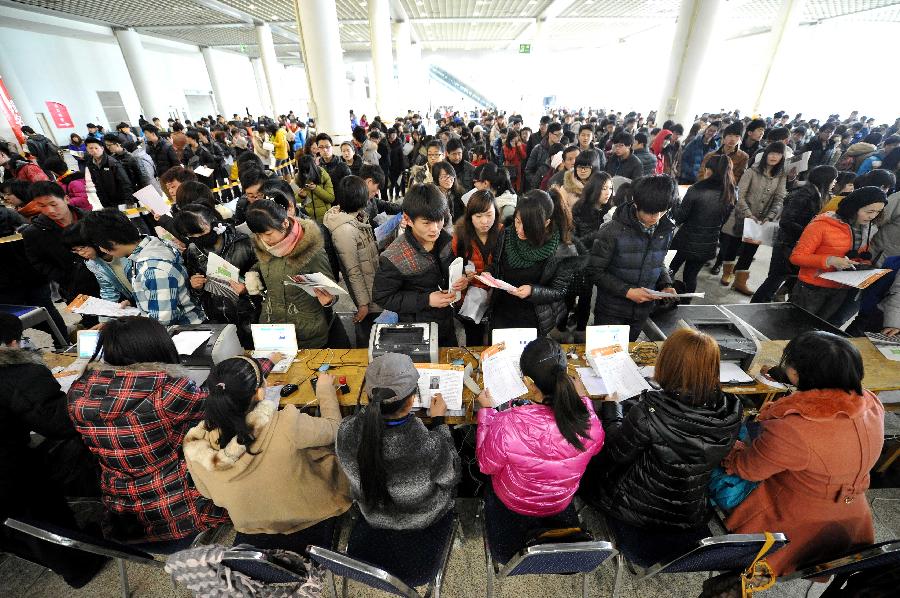 Students are seen at Shungeng International Exhibition Center as they signing up for the Major of Arts Admissions Test (MAAT) in Jinan, capital of east China's Shandong Province, Feb. 18, 2013. The 2013 MAAT for colleges in Shandong is scheduled to start here on Feb. 20, 2013. (Xinhua/Xu Suhui) 