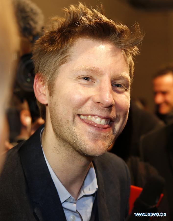 Christopher Bailey, the Chief Creative Officer of Burberry, is interviewed by the media after the Burberry Prorsum Autumn/Winter 2013 Womenswear Show at Kensington Gardens during London Fashion Week in London, Britain, on Feb. 18, 2013.(Xinhua/Wang Lili) 