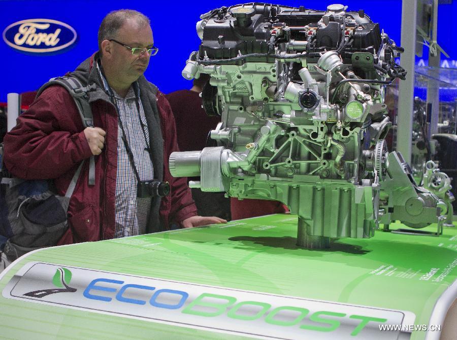 An audience looks at a 3.5L EcoBoost V6 Truck Engine at the Metro Toronto Convention Centre of Toronto, Canada, Feb. 18, 2013. The Canadian International Auto Show is celebrating its 40th birthday from Feb. 14 to Feb. 24 with an extensive roster of new vehicle rollouts, while bringing the latest in green auto technology to car enthusiasts. (Xinhua/Zou Zheng)