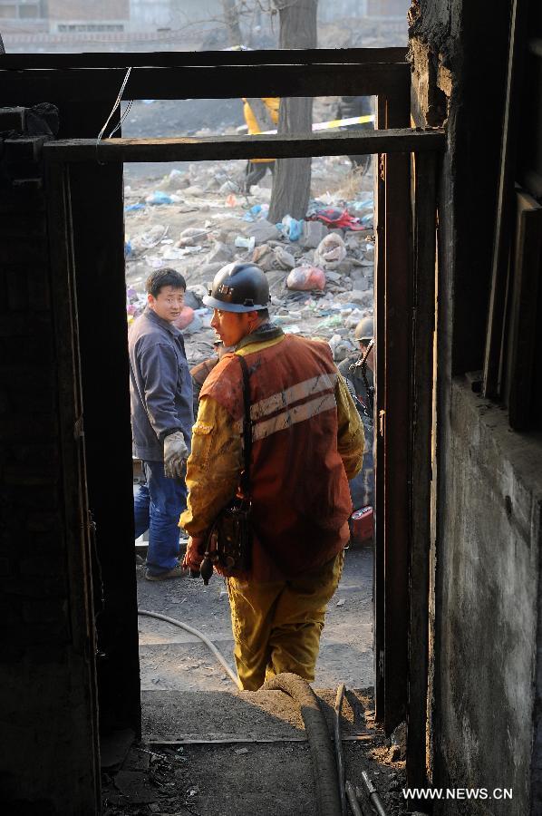 A rescuer walk out of a coal mine in Madixiang Community of Yangquan, north China's Shanxi Province, Feb. 19, 2013. Six people have been trapped underground since a coal mine in Yangquan City was flooded at about 4 a.m. Tuesday, when 12 people were conducting illegal mining operations, the local government said.(Xinhua/Fan Minda)