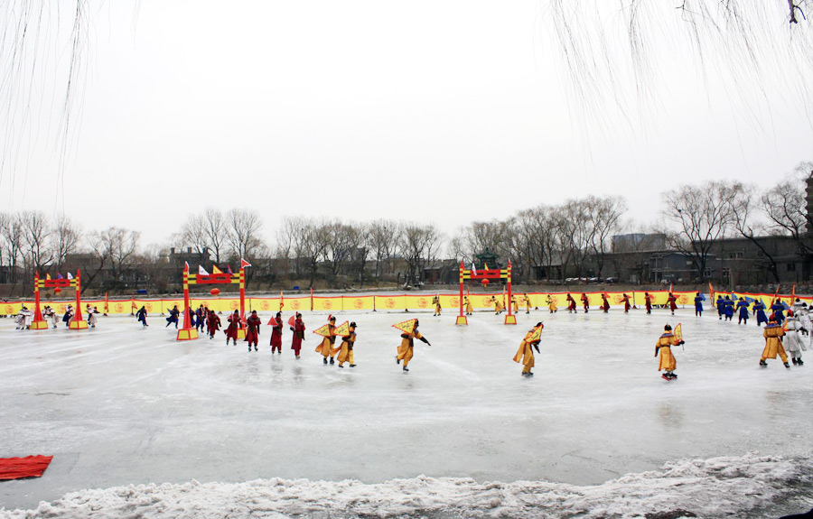 People wearing Qing dresses skate on ice. (PhotoChina/ Xiao Dong)