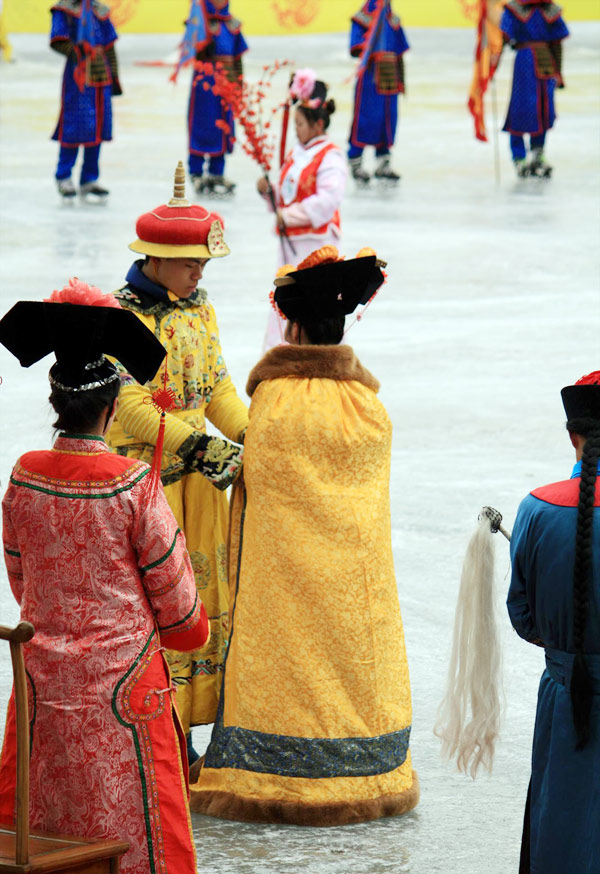 People wearing Qing dresses skate on ice. (PhotoChina/ Xiao Dong)