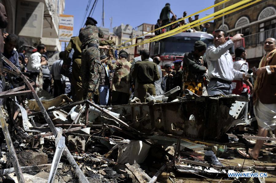 Policemen collect wreckage of the crashed plane in Sanaa, Yemen, Feb. 19, 2013. A Yemeni military helicopter on a training mission crashed in a crowded neighborhood in central capital Sanaa on Tuesday, leaving at least nine people dead and 23 others injured, local officials and witnesses said. (Xinhua/Mohammed Mohammed)  