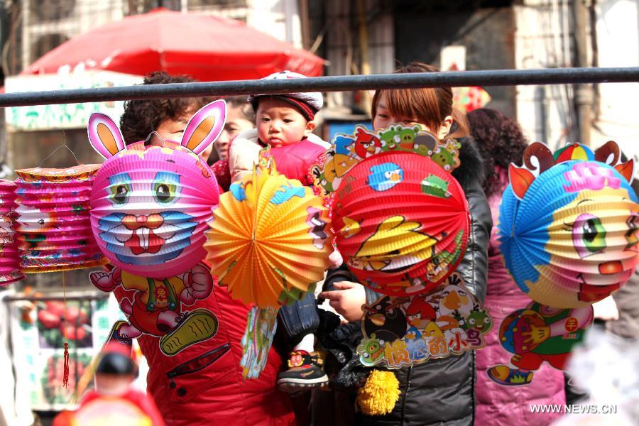 Customers choose lanterns at a market in Bozhou, east China's Anhui Province, Feb. 20, 2013. An annual lantern sales boom appeared with the approaching of the Lantern Festival which falls on Feb. 24 this year. (Xinhua/Liu Qinli) 