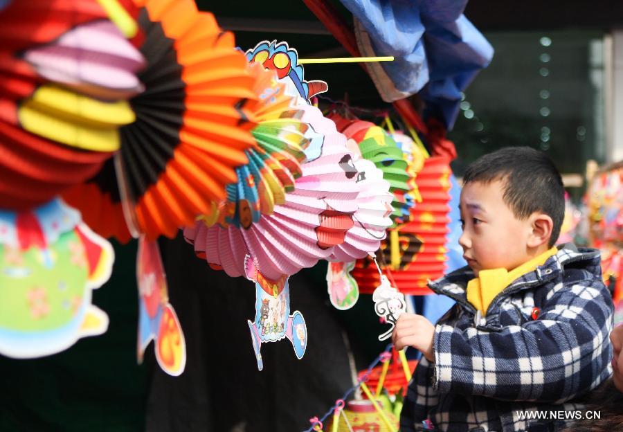 A boy chooses lanterns at a market in Huaibei, east China's Anhui Province, Feb. 20, 2013. An annual lantern sales boom appeared with the approaching of the Lantern Festival which falls on Feb. 24 this year. (Xinhua/Wang Haoyu) 